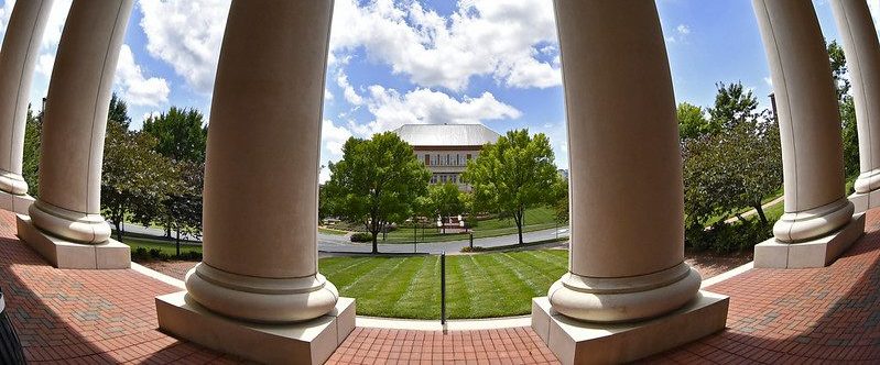 A view looking through columns at another campus building.