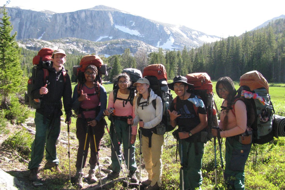 A group of scholars pose for a photo during a hike at the NOLS expedition.