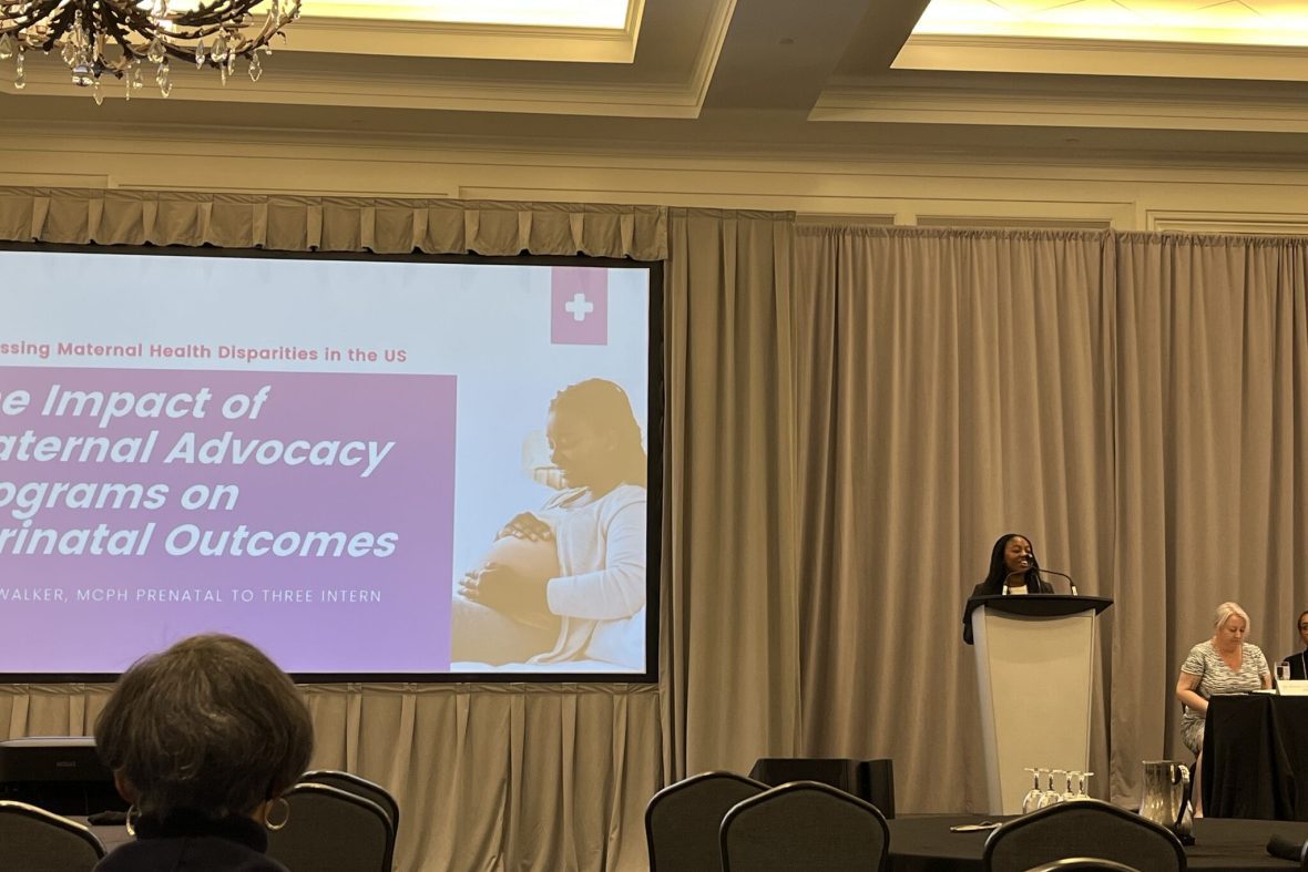A scholar presenting her research from a podium.