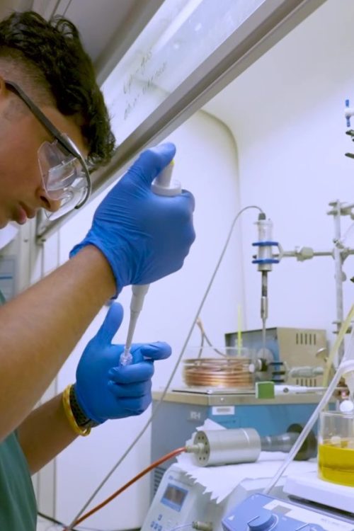 A scholar conducting research in a lab.