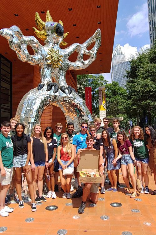 A group of scholars standing outside of a popular art museum in Charlotte.
