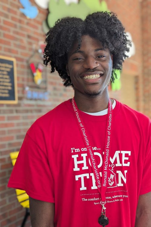 A scholar smiling outside of the Ronald McDonald house.