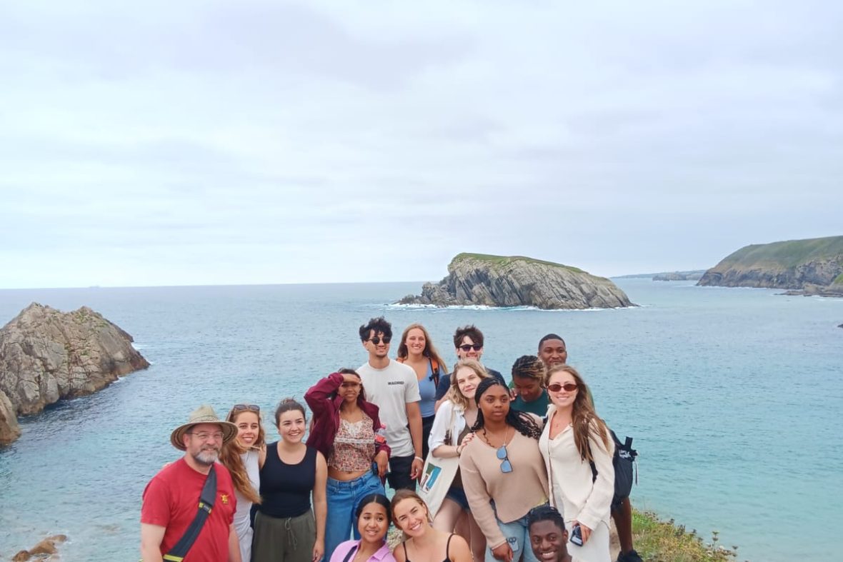 Scholars standing on a cliff in front of the ocean in Santander, Spain