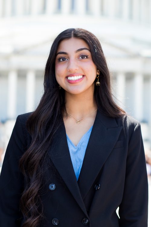 Scholar standing in front of a building in Washington, DC