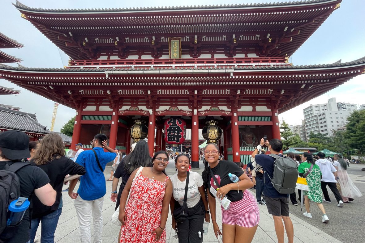 Scholars in front of a monument in Japan